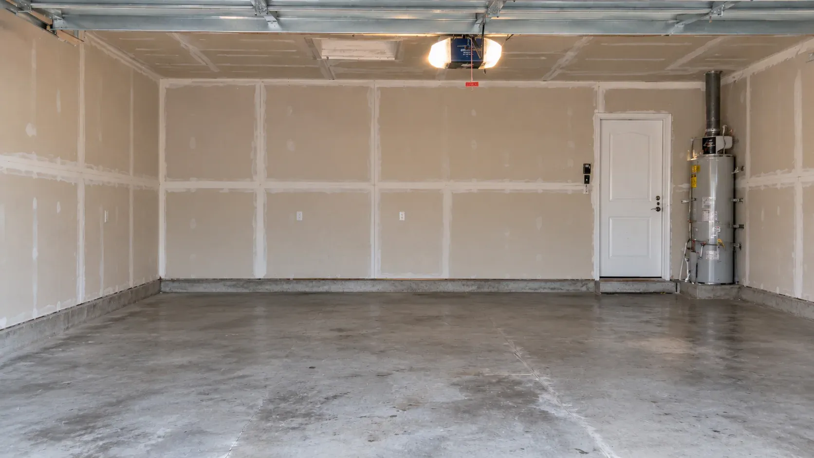 After: the same garage emptied to bare walls and a clear concrete floor.